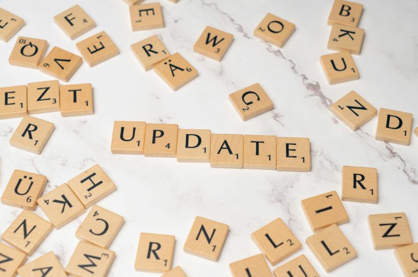 scrabble letters spelling the word update on a white table